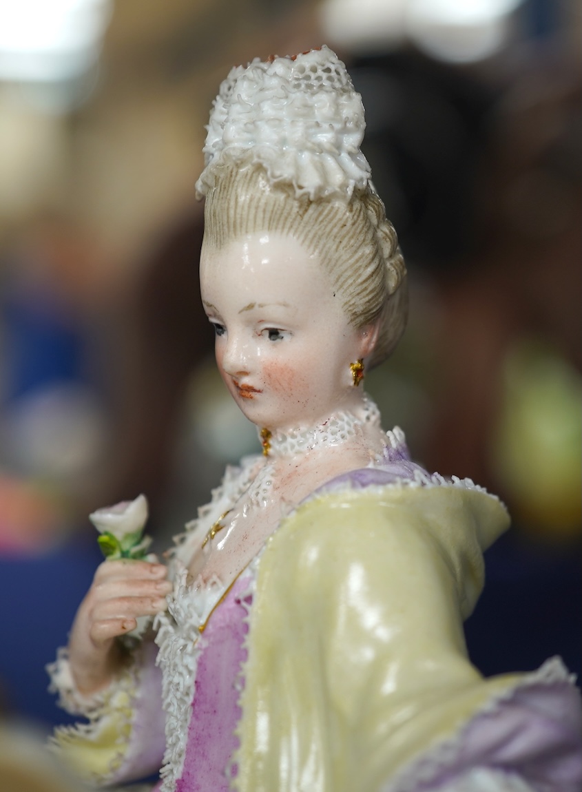 A late 19th century Meissen figure of Sight, from the Senses, a seated lady at her dressing table, crossed swords mark and incised E3 mark to base, 14cm high